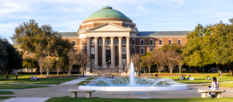 university campus with fountain and historic academic building showcasing student life and campus environment